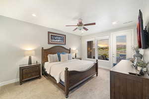 Bedroom with light carpet, baseboards, recessed lighting, a ceiling fan, and access to exterior