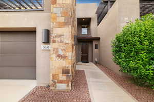 Entrance to property with stucco siding