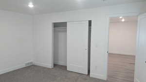 Unfurnished bedroom with a closet and baseboards