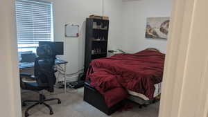 Bedroom featuring an office area and carpet