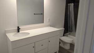 Full bath featuring toilet, vanity, shower / bath combo with shower curtain, and wood finished floors