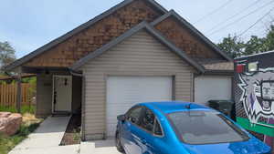 View of front of property with an outbuilding and an attached garage