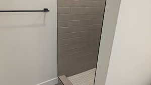 Full bath featuring tiled shower