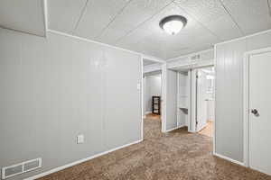 Carpeted empty room with baseboards