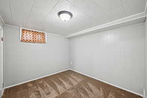 Unfurnished room with carpet flooring and baseboards