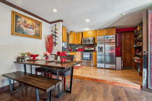 Kitchen featuring stainless steel appliances, light wood finished floors, recessed lighting, crown molding, and tasteful backsplash