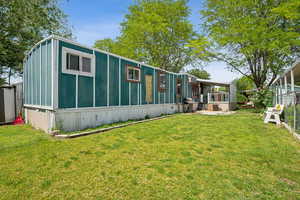 View of side of property with a lawn