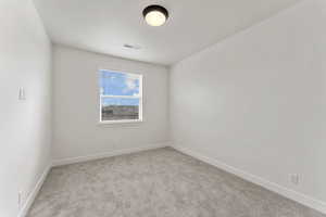 2nd bedroom with carpet floors and baseboards