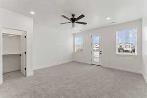 Unfurnished bedroom with carpet floors, multiple windows, baseboards, and recessed lighting