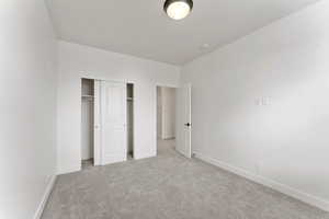2nd bedroom with carpet floors, baseboards, and a closet