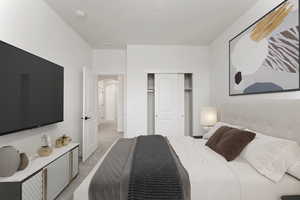 3rd Bedroom with light colored carpet, a closet, and arched walkways