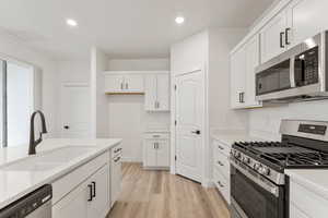 Kitchen featuring appliances with stainless steel finishes quartz countertops