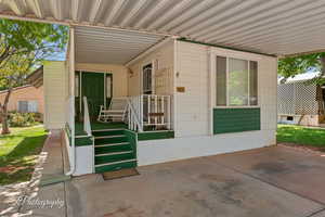 Doorway to property featuring covered porch
