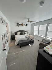 Bedroom featuring carpet floors, baseboards, and ceiling fan