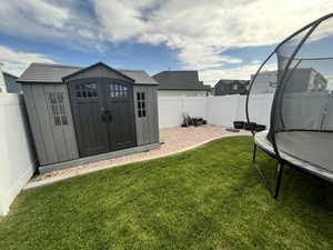View of yard featuring a trampoline
