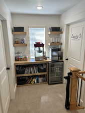 Sitting room with beverage cooler and carpet floors