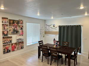 Dining room featuring light wood-style flooring, baseboards, and recessed lighting