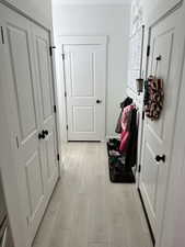 Hallway with light wood-style floors