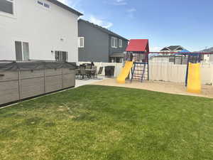View of yard featuring a playground and a patio area