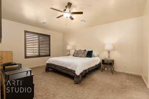 Carpeted bedroom with baseboards and a ceiling fan