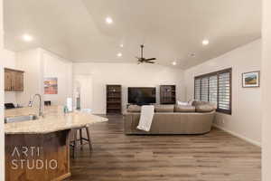 Living room with dark wood-style floors, lofted ceiling, recessed lighting, a ceiling fan, and baseboards