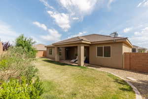Back of property featuring stucco siding, a patio area, and a tiled roof