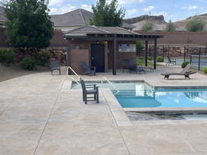 Community pool with a mountain view and a patio area