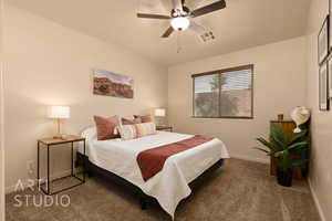Bedroom featuring carpet floors, baseboards, and a ceiling fan