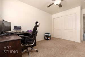 Carpeted home office with ceiling fan