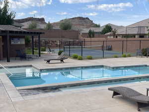 Community pool featuring a mountain view, a tennis court, and a patio