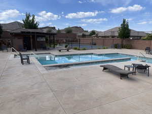 Community pool with a patio