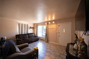 Living area featuring a textured ceiling