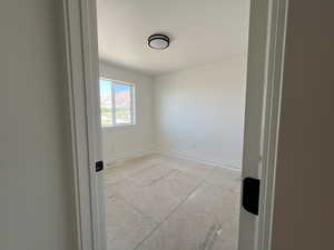 Unfurnished room featuring baseboards