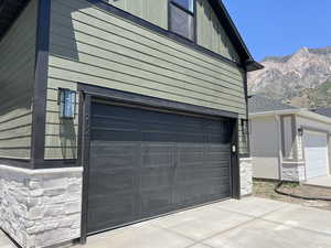Garage featuring a mountain view and concrete driveway