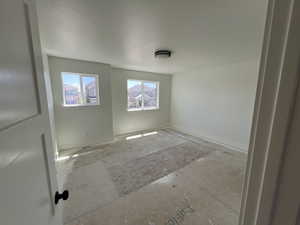 Unfurnished room with a textured ceiling