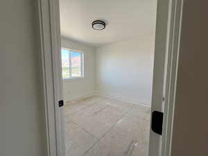 Unfurnished room with baseboards