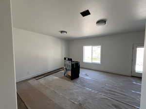 Unfurnished room featuring baseboards and a textured ceiling
