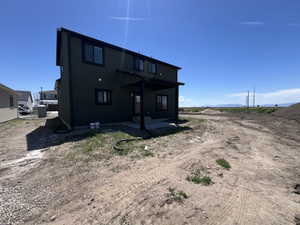 Rear view of property featuring a patio area and stucco siding