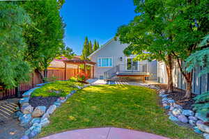 View of yard featuring a pergola and a deck