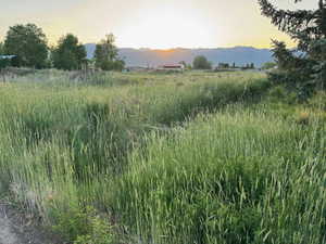 View of mountain backdrop featuring rural landscape