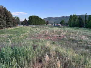 View of mountain backdrop with rural landscape