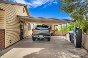 View of parking with an attached carport