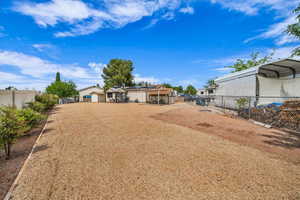 Fenced yard with a detached carport