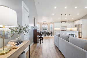 Living room featuring light wood finished floors, recessed lighting, and baseboards