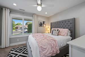 Carpeted bedroom featuring baseboards, recessed lighting, and ceiling fan