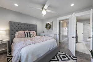 Carpeted bedroom with recessed lighting and a ceiling fan