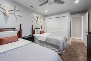 Bedroom with a closet, carpet flooring, recessed lighting, baseboards, and ceiling fan