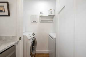 Laundry area featuring washer and clothes dryer and baseboards