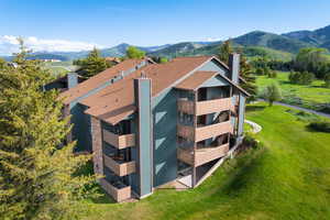 Aerial view of property and surrounding area with a mountain backdrop