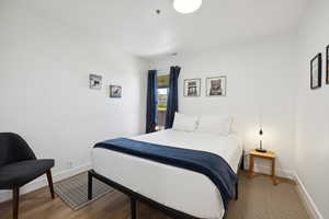 Bedroom featuring baseboards and wood finished floors